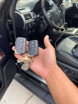 A person holding two car keys, indicating a duplicate car key for easy access and convenience.