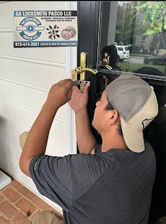 A locksmith from AA Locksmith Pasco LLC working on a door lock with professional tools, representing expert commercial locksmith services.